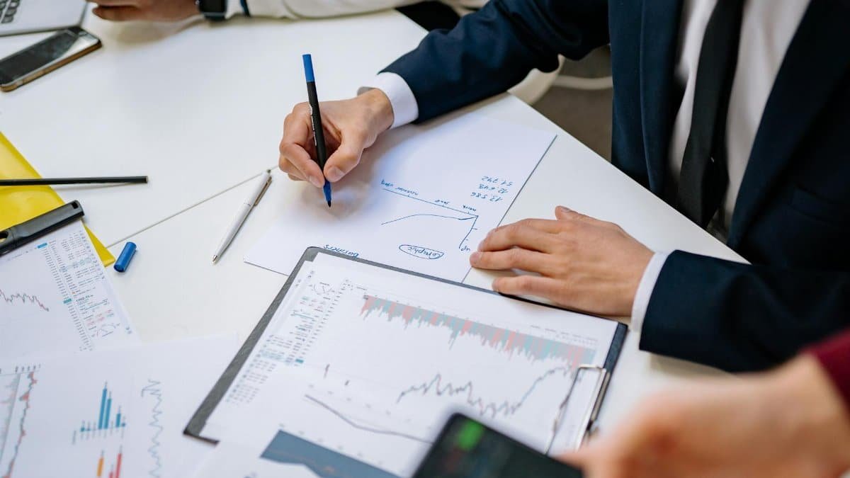 Professionals analyzing financial charts in a corporate setting.