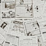 A flat lay of Arabic newspapers in Fès, Morocco, showcasing diverse articles.