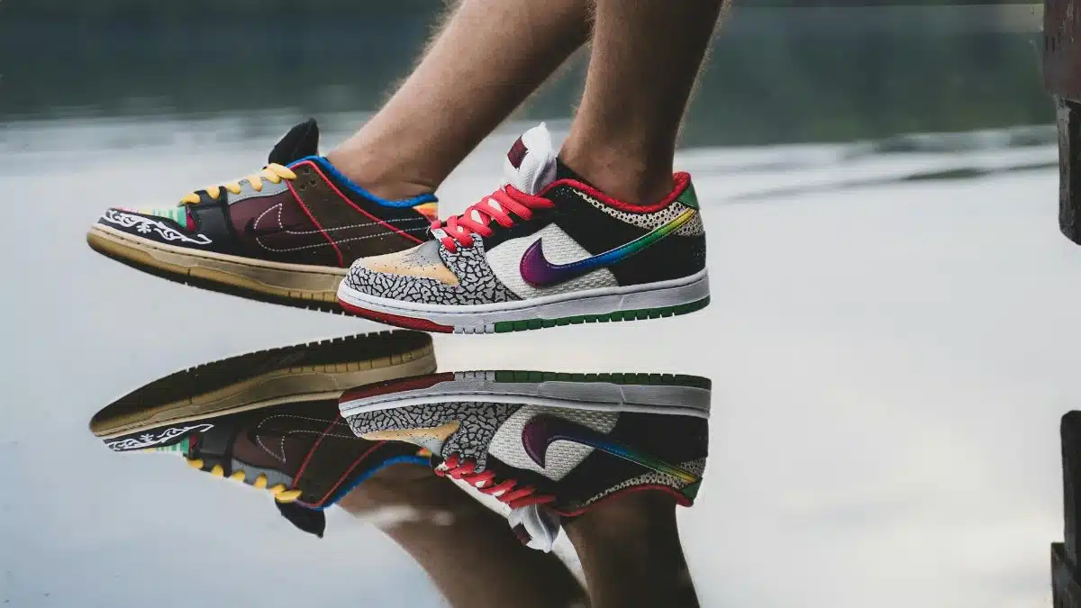 Vibrant sneakers reflecting on a calm lake, showcasing unique footwear style.