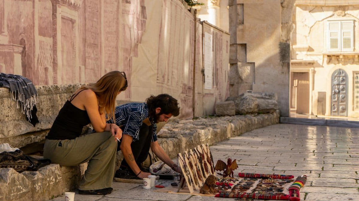 Artisans displaying handcrafted goods in historic Split, Croatia.