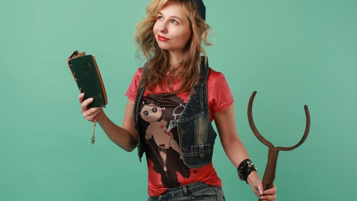 Young woman with book and wand in a modern portrait studio shoot.