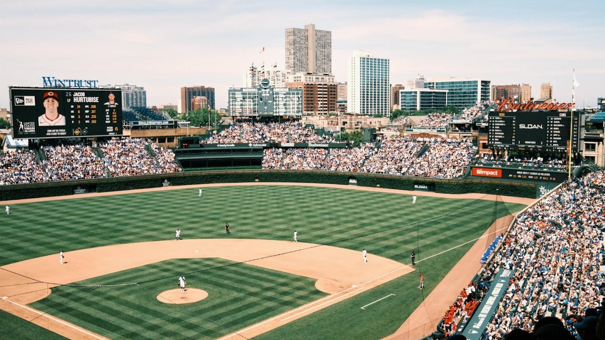 Wide-angle shot of Wrigley Field filled with spectators during a baseball game in Chicago.