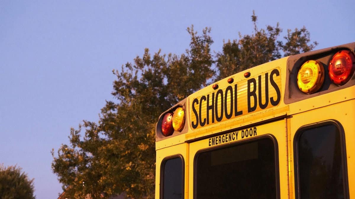 Nostalgic view of a yellow school bus parked outdoors during sunset.