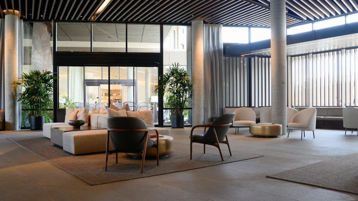 Spacious hotel lobby featuring contemporary furniture and natural lighting.
