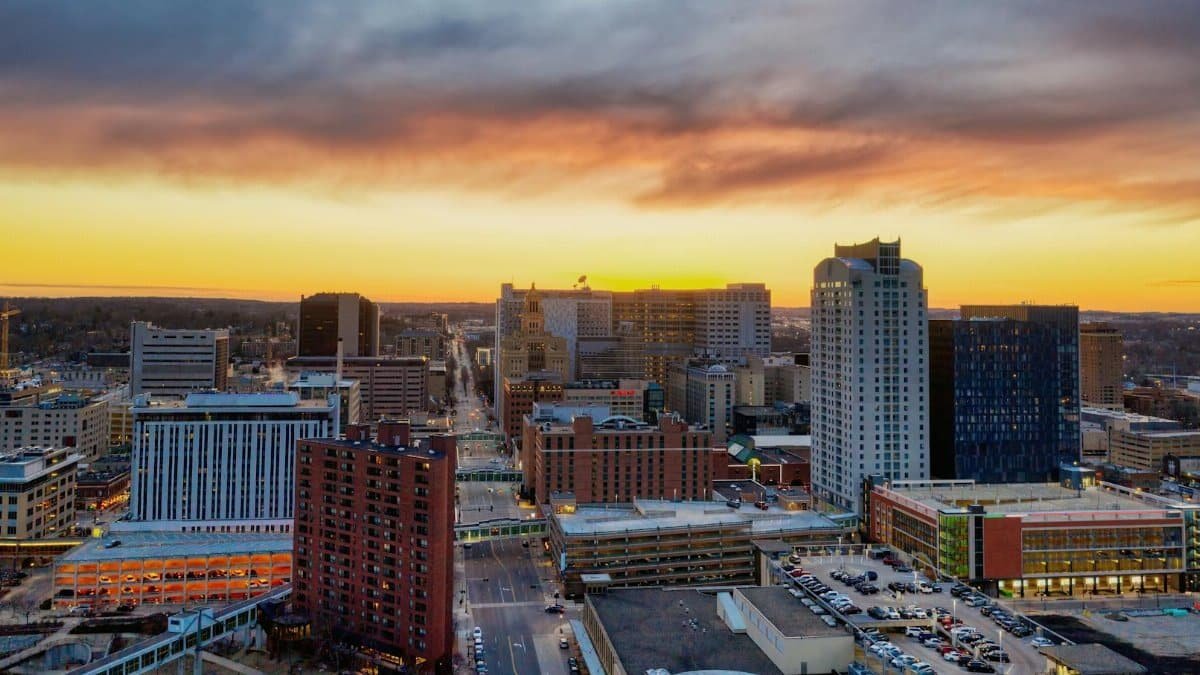 Stunning aerial image of Rochester, Minnesota skyline at sunset with dramatic skies.