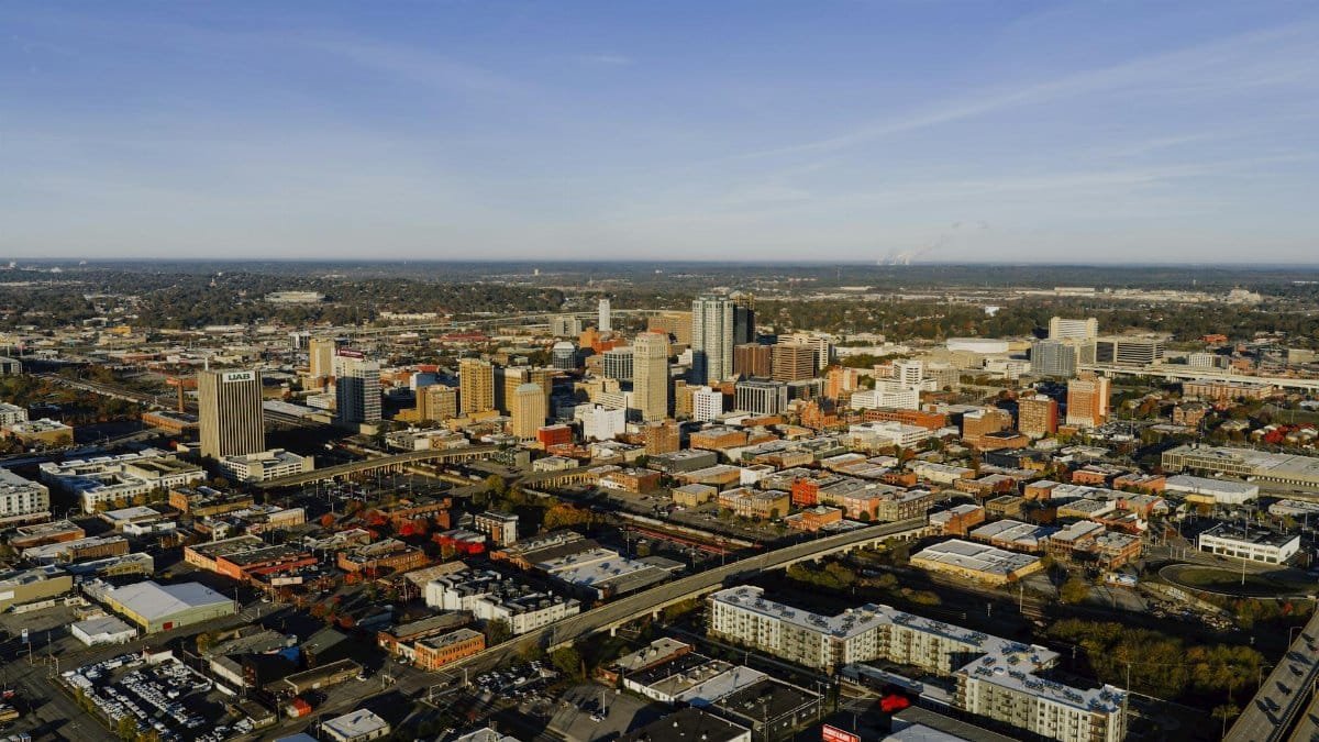 Aerial photograph showcasing Birmingham, Alabama's urban skyline and city layout.