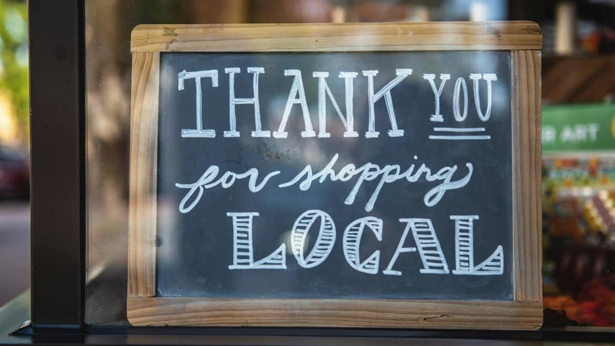 Chalkboard sign encourages shopping local in San Luis Obispo store.