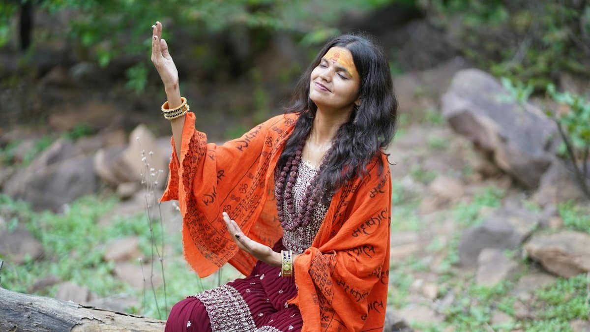 Woman meditating outdoors in a serene natural setting, embracing peace and spirituality.