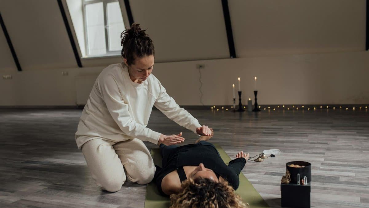 A peaceful indoor scene of alternative healing, featuring a spiritual healer practicing a ritual.