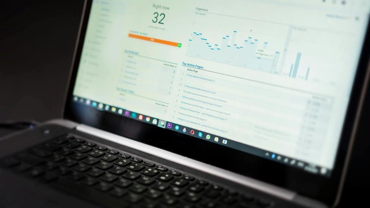 A laptop displaying an analytics dashboard with real-time data tracking and analysis tools.
