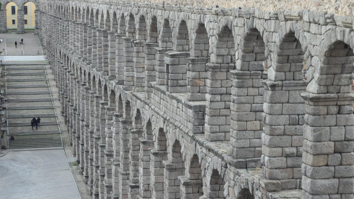 Explore the majestic arches of the Roman aqueduct in Segovia, showcasing ancient engineering marvel.