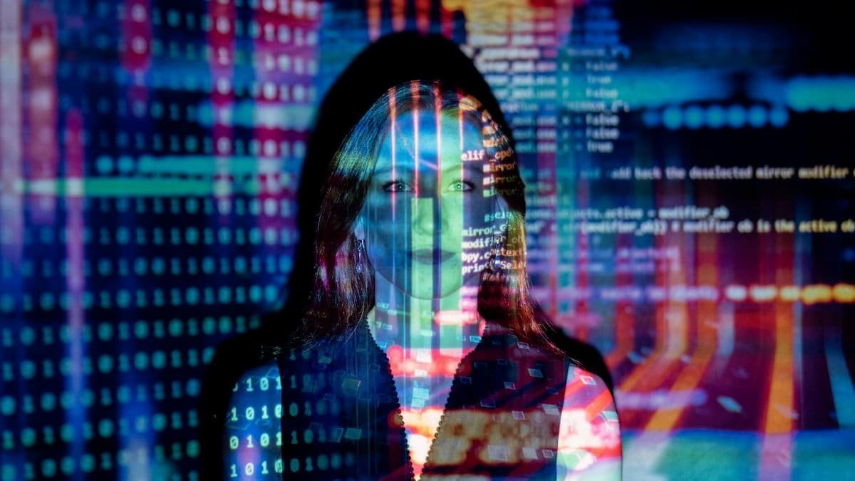 A woman with digital code projections on her face, representing technology and future concepts.