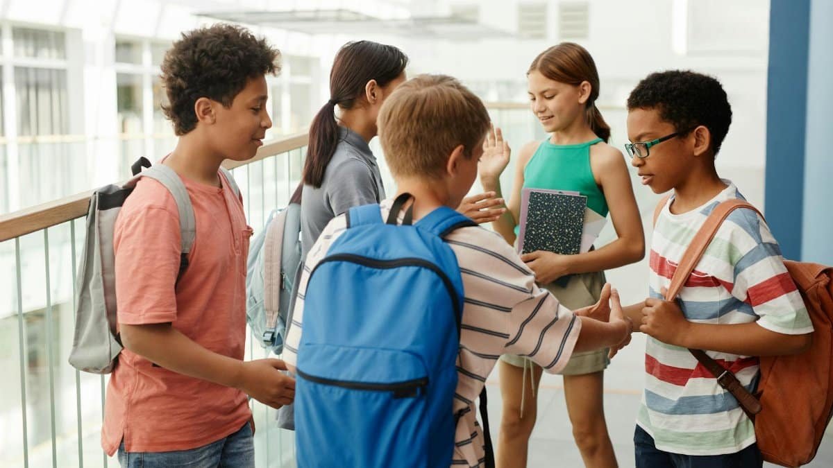 A diverse group of students interacting in a school hallway, fostering social connections.