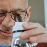 Close-up of a male scientist using a microscope in a laboratory.