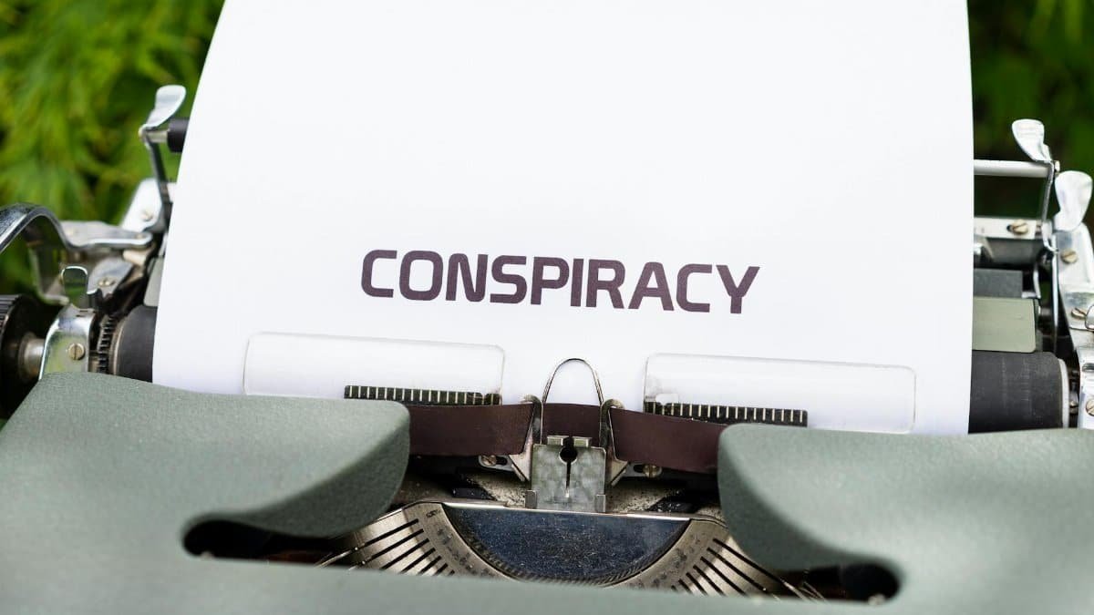 A typewriter with paper displaying the word 'CONSPIRACY.'