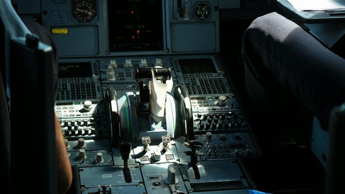 Detailed view of an airplane cockpit showcasing control panel and levers.