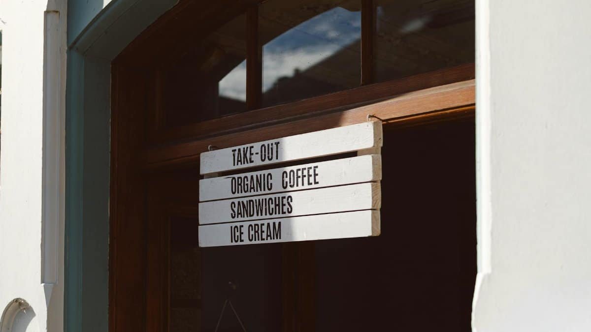 An inviting coffee shop entrance sign with menu options in Dunkeld, Scotland.