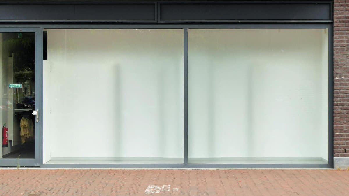 Clean modern storefront with large glass windows, perfect for retail display.