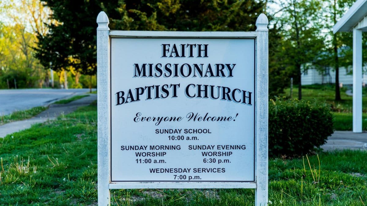 Sign for Faith Missionary Baptist Church with service times in Kansas City, MO.