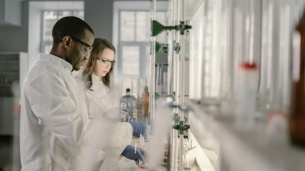 Two scientists conducting research in a modern laboratory setting with focus on chemistry.
