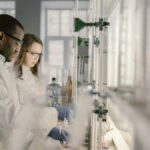 Two scientists conducting research in a modern laboratory setting with focus on chemistry.