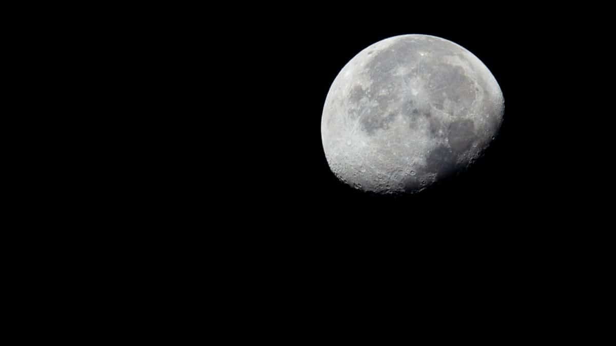 Close-up shot of the moon in black and white against a dark sky.