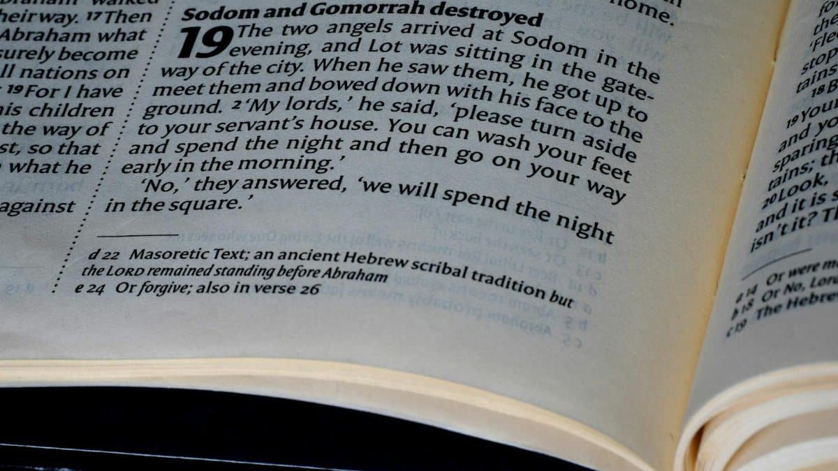 Detailed close-up of a page from the Bible's Book of Genesis, highlighting scripture text.