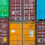 Vividly colored shipping containers stacked together, showcasing global trade and logistics.