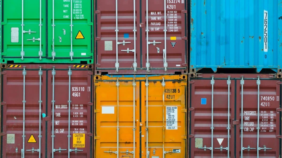 Vividly colored shipping containers stacked together, showcasing global trade and logistics.