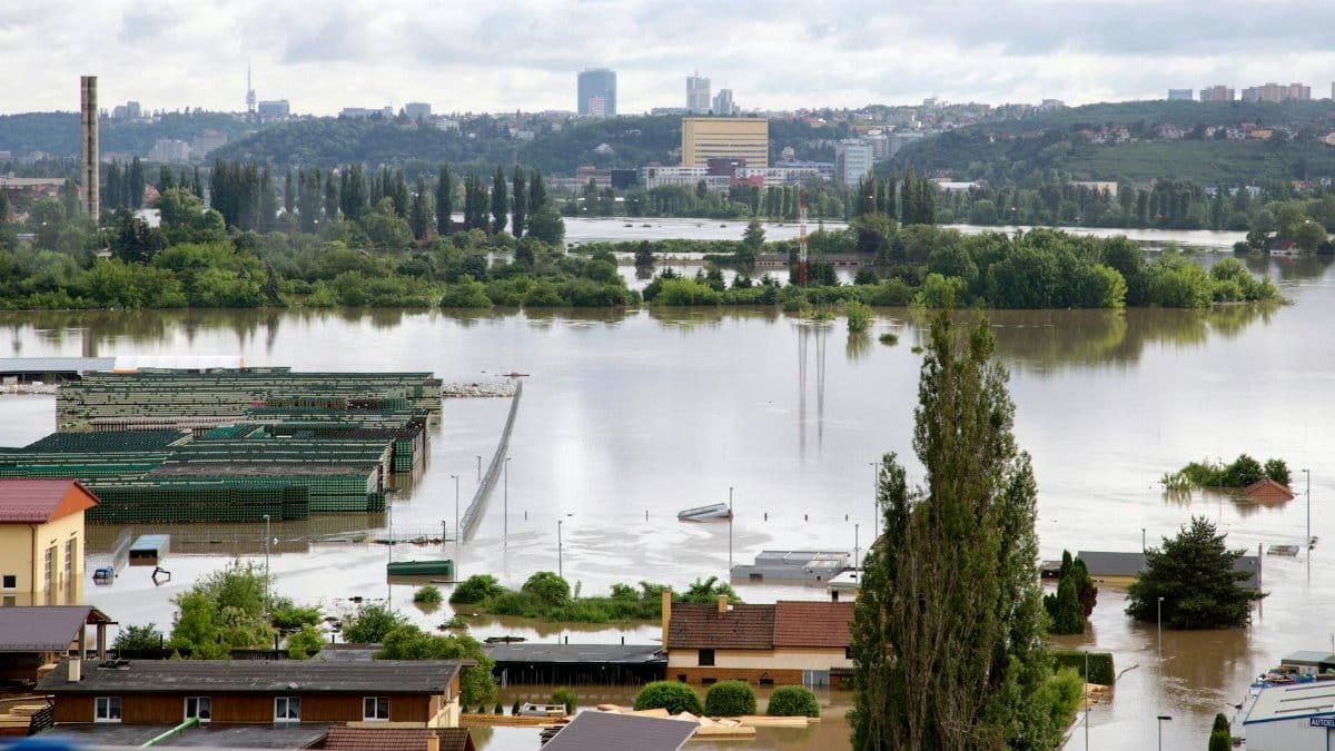 Aerial shot of a city affected by severe flooding with submerged buildings and roads.