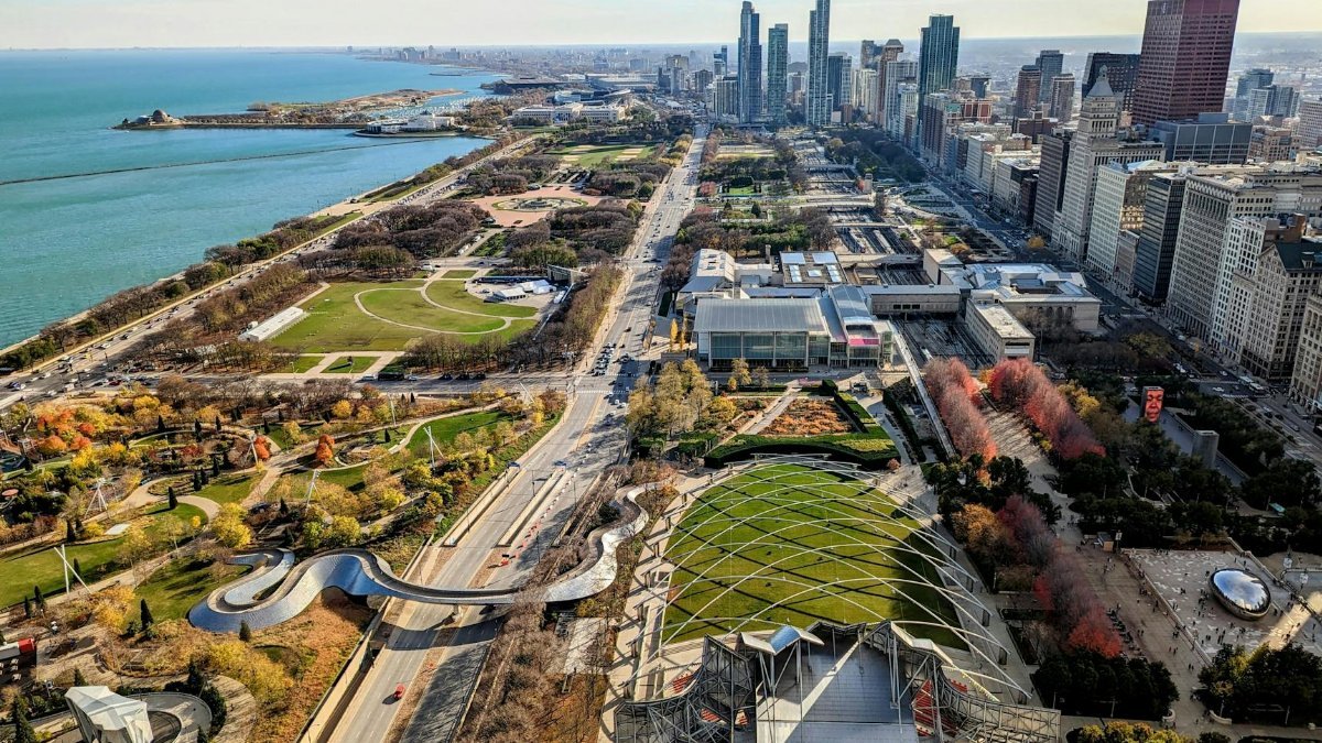 Stunning aerial shot of Chicago featuring Millennium Park, Lake Michigan, and downtown skyline.