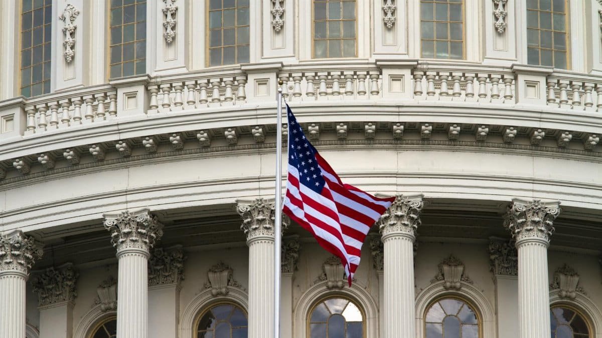Close-up of the American flag waving outside the United States Capitol in Washington, DC.