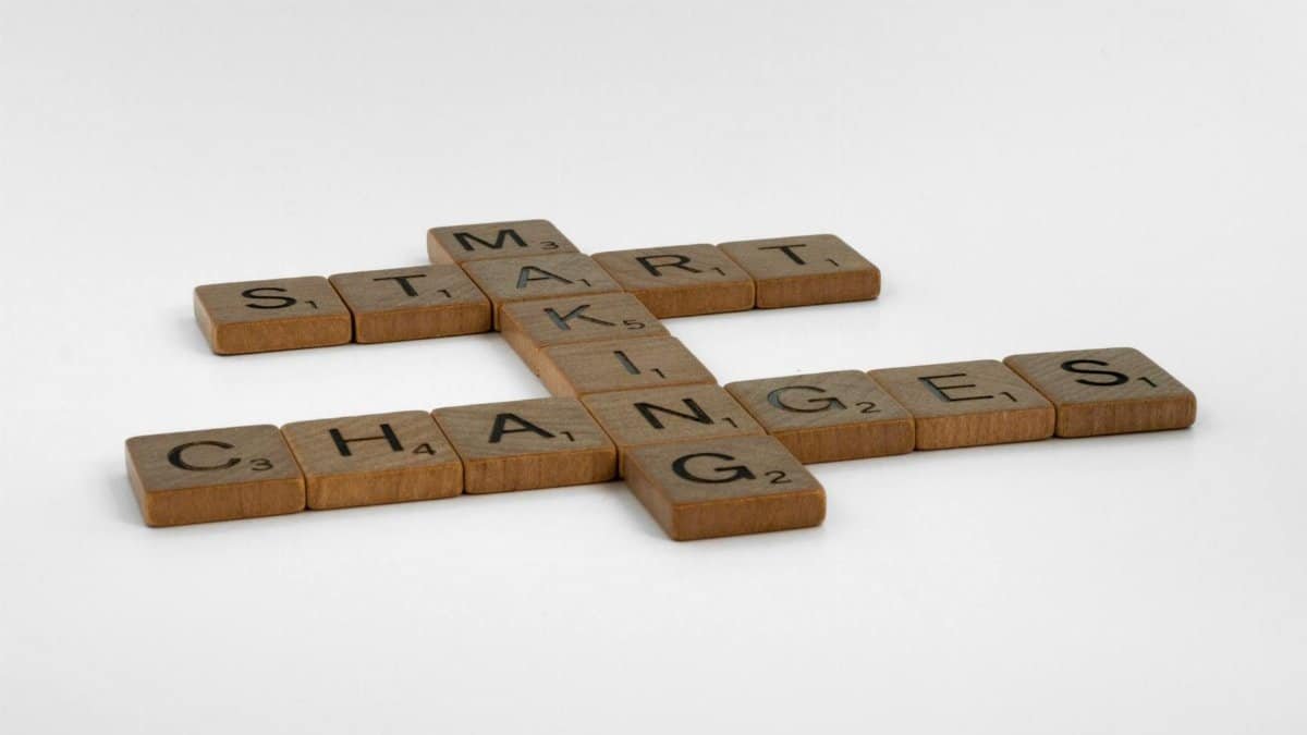 Scrabble tiles spelling 'Start Making Changes' on a white surface, inspiring change