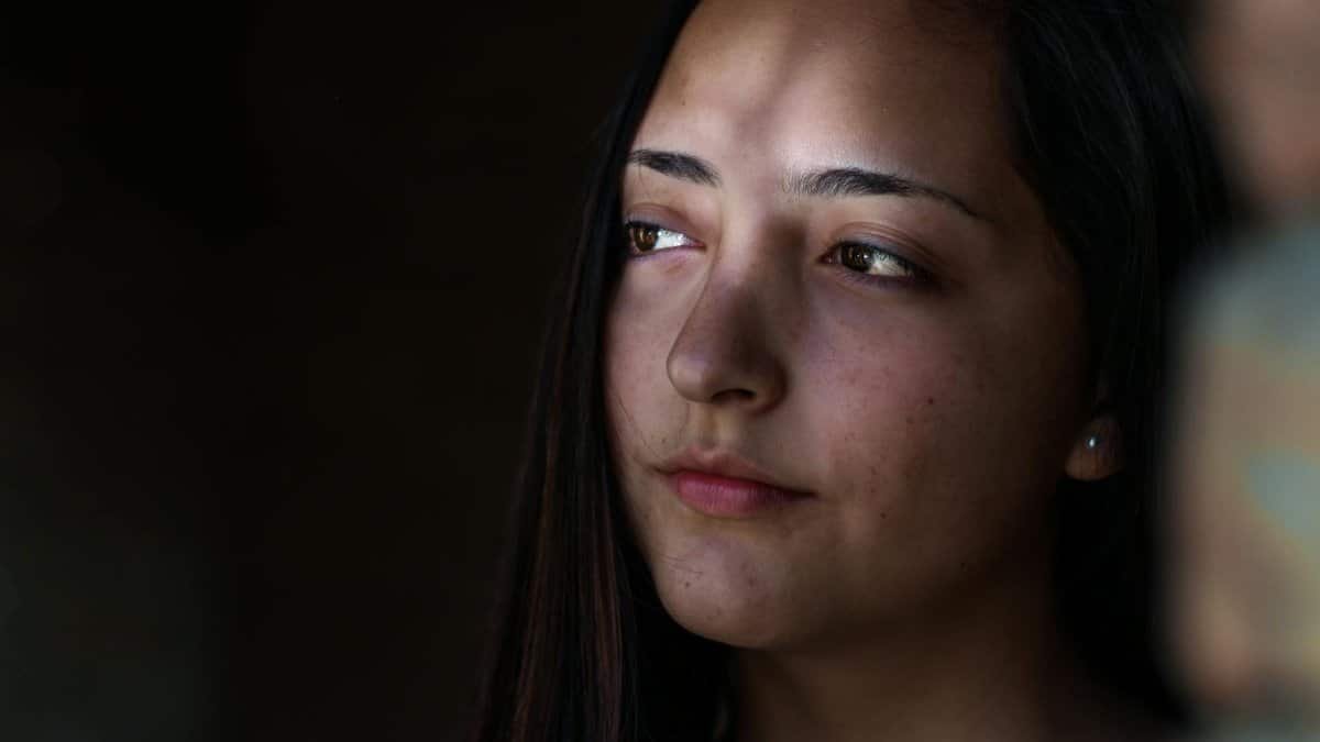 A serene portrait of a young woman with soft, natural lighting, conveying contemplation and grace.
