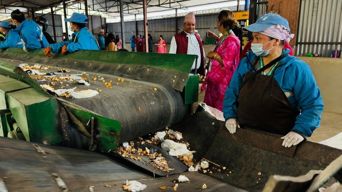Workers sorting waste in a recycling facility in Butwal, Nepal, showcasing environmental sustainability efforts.