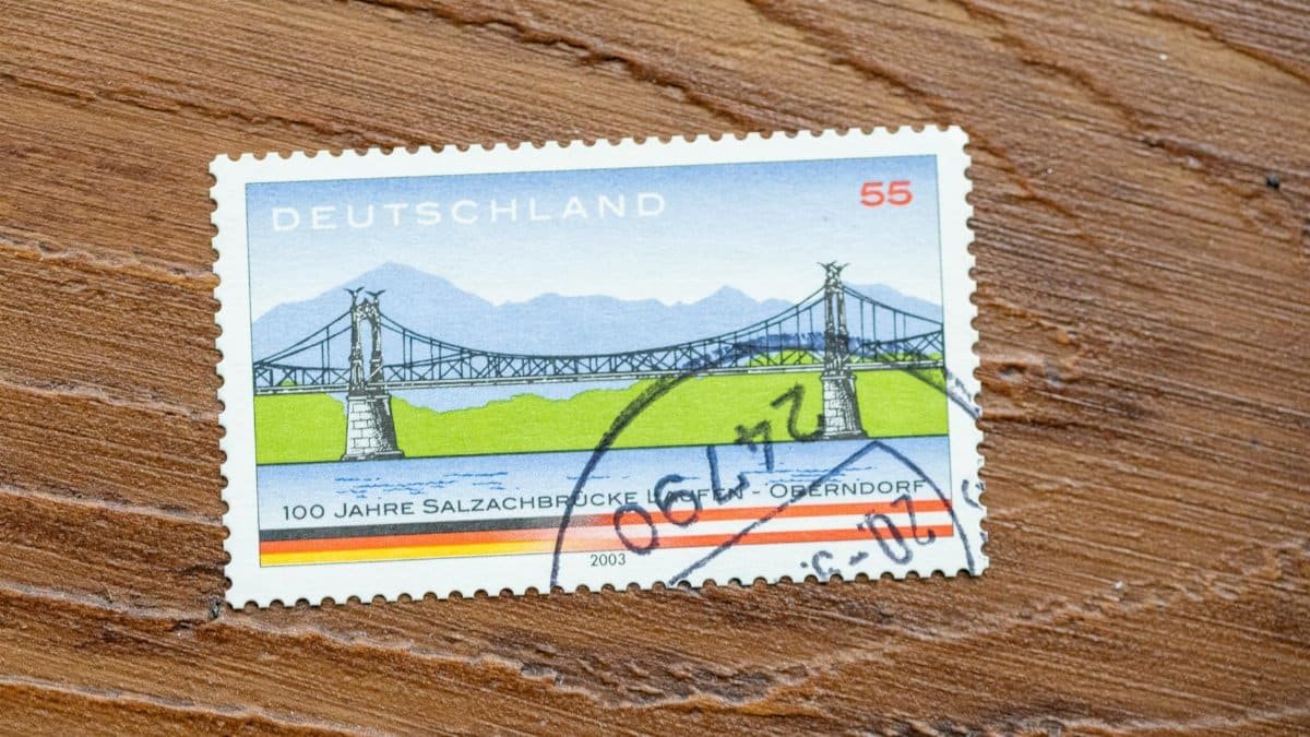 Vintage German stamp shows scenic bridge, highlighting design and postal history.
