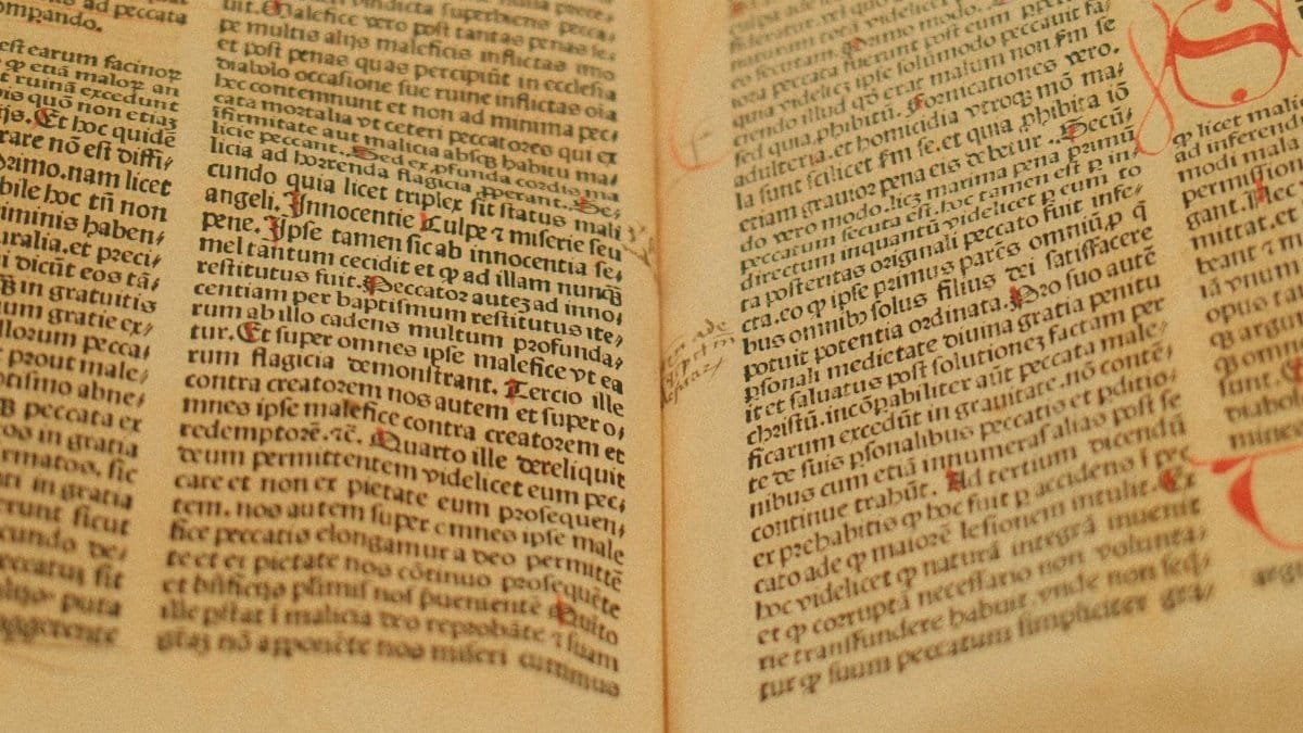 Detailed image of an ancient manuscript featuring Latin text on yellowed pages.