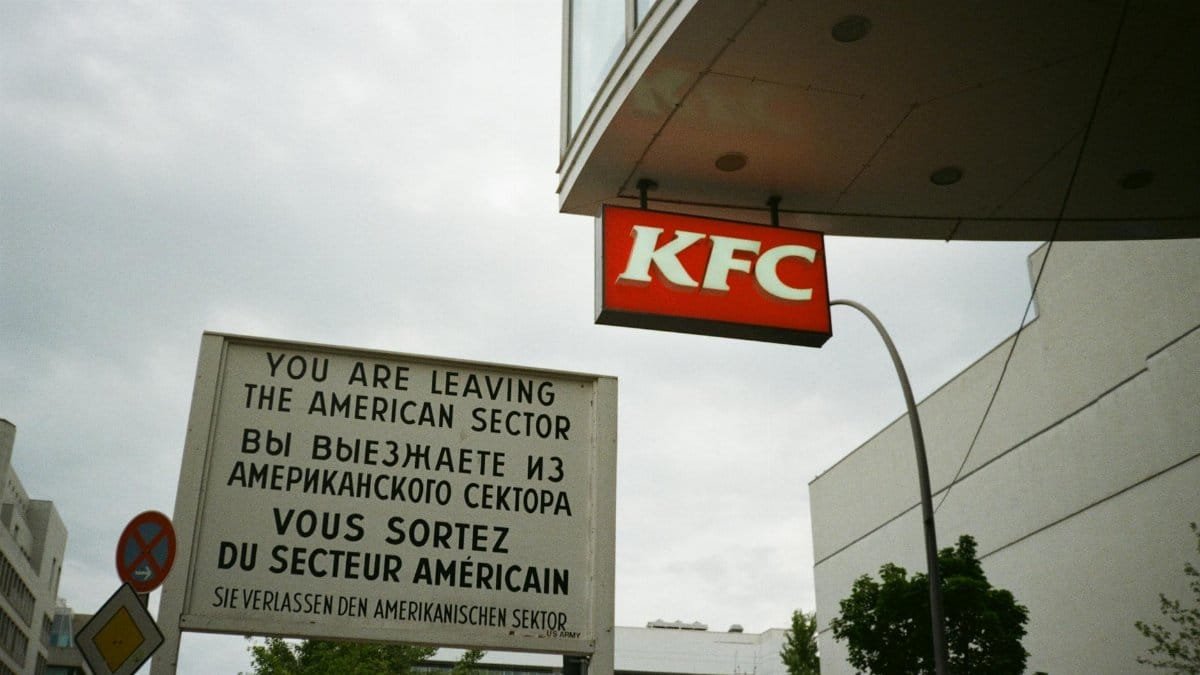 Famous Berlin sign with KFC, symbolizing the city's historical divide.