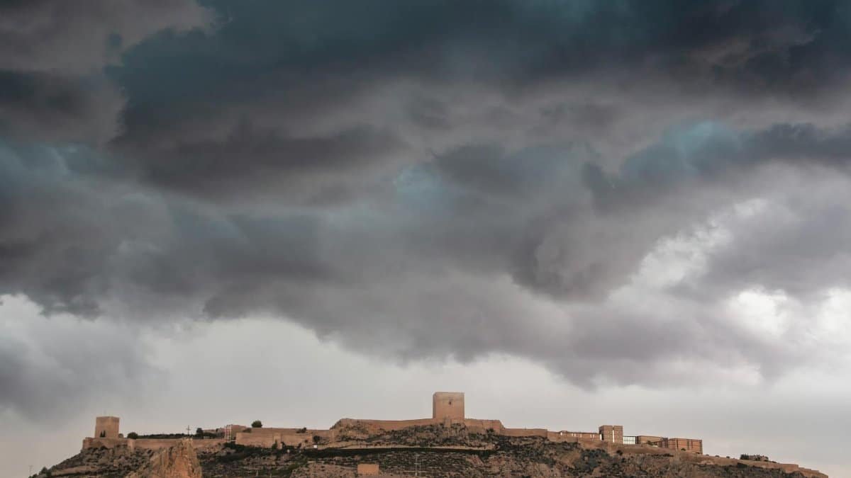 Capture of a medieval fortress under dramatic storm clouds, creating a moody and historical atmosphere.