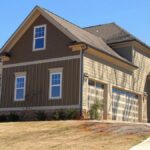 Cozy family home for sale in suburb with spacious garage and landscaped lawn.