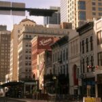Charming street view of downtown Houston with historic buildings on a sunny day.