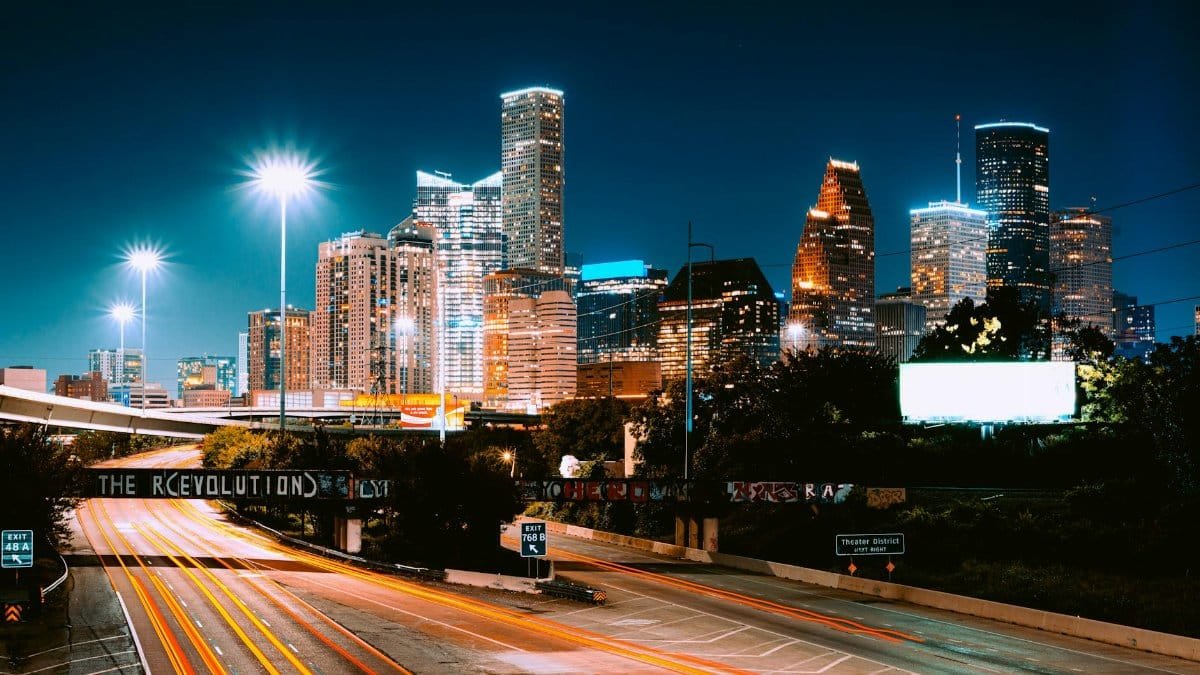 Captivating view of Houston's skyline at night with light trails and illuminated buildings.