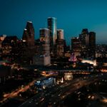 Stunning aerial view of downtown Houston's illuminated skyscrapers at dusk.