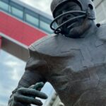 Close-up of a football player statue outside a modern stadium in Cleveland, Ohio.