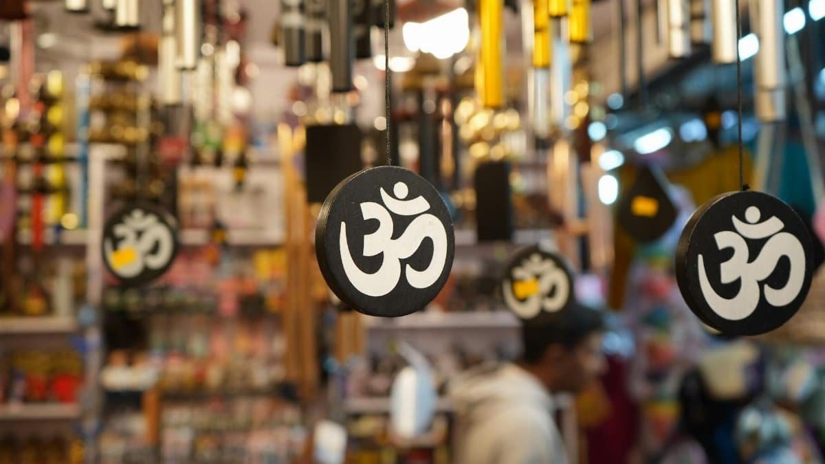 Decorative Om symbols hanging in a busy shop, creating a spiritual atmosphere.