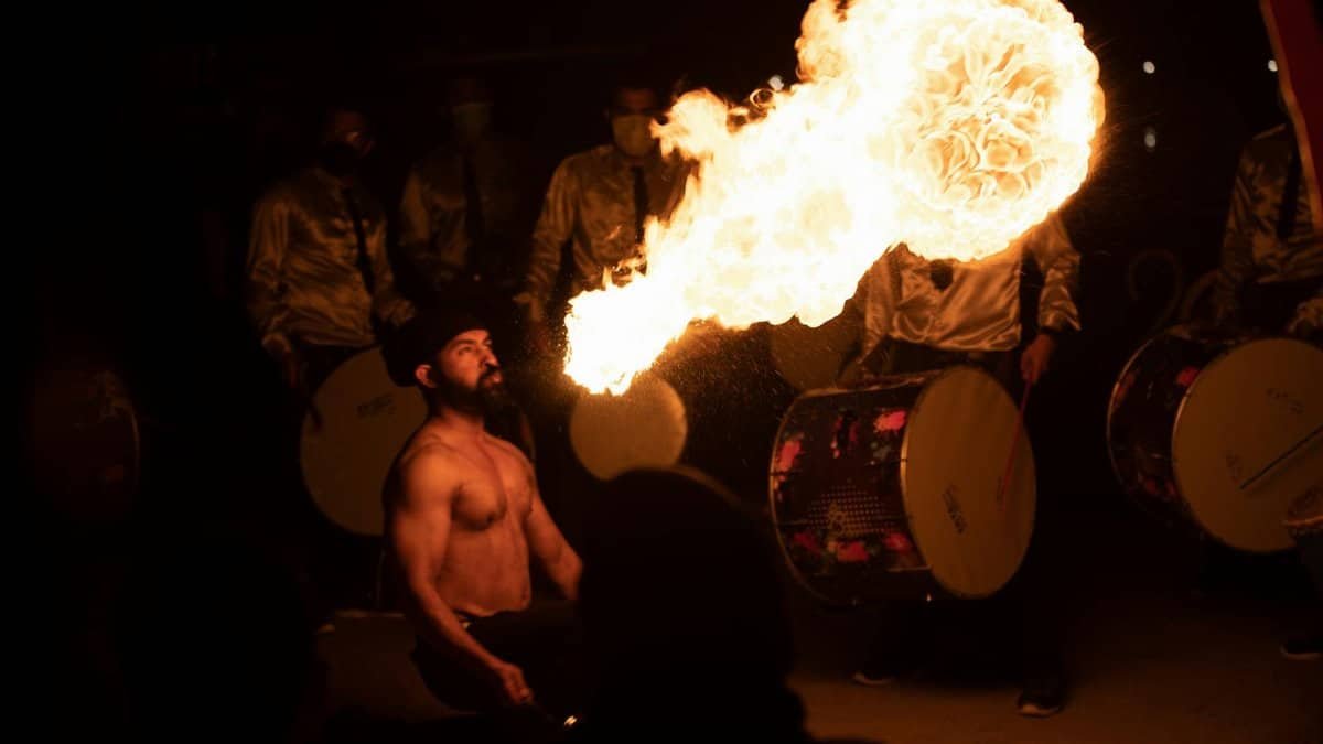 A captivating fire breathing performance at night in Bahrain with drummers.