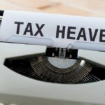 Close-up of a vintage typewriter displaying the words 'TAX HEAVEN', conveying a conceptual financial theme.