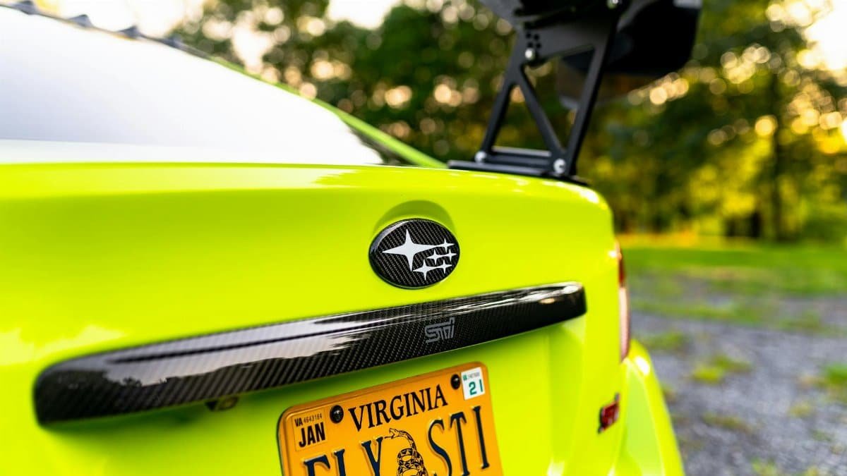 Vibrant green sports car with Virginia license plate in an outdoor setting.