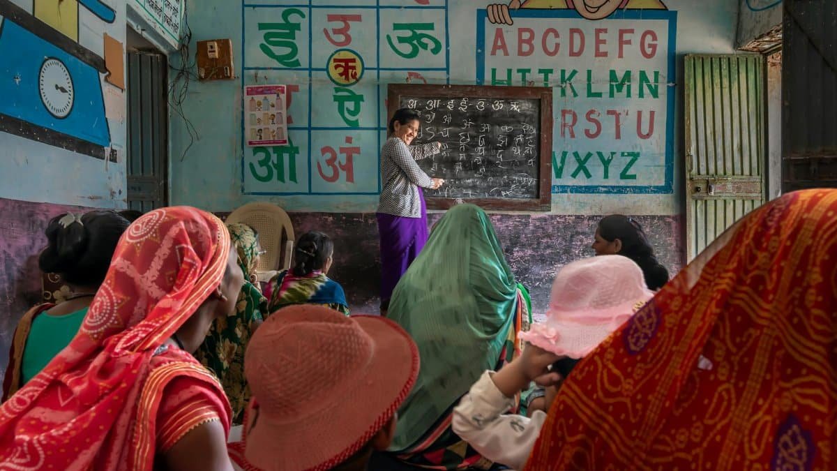 Women attending an educational session in a rural Indian classroom, promoting inclusivity and empowerment.