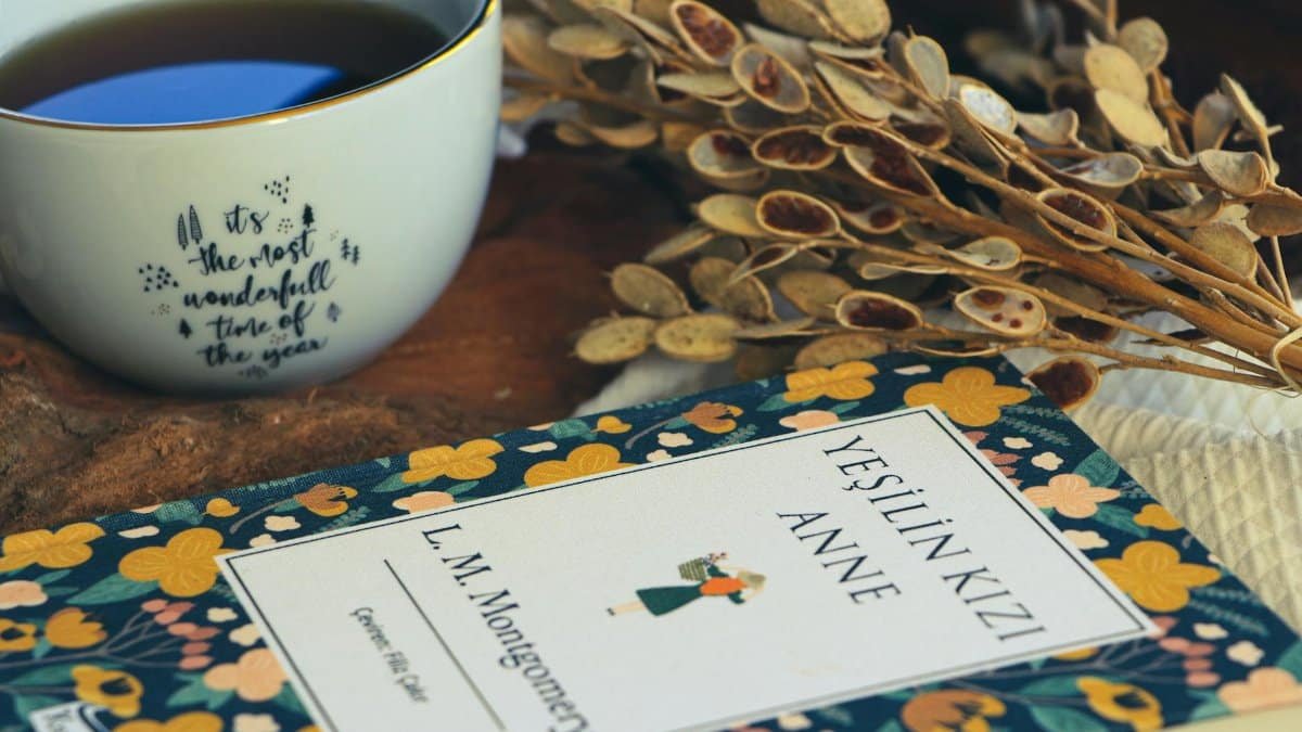 A warm, inviting scene with a floral book and tea on a rustic table.